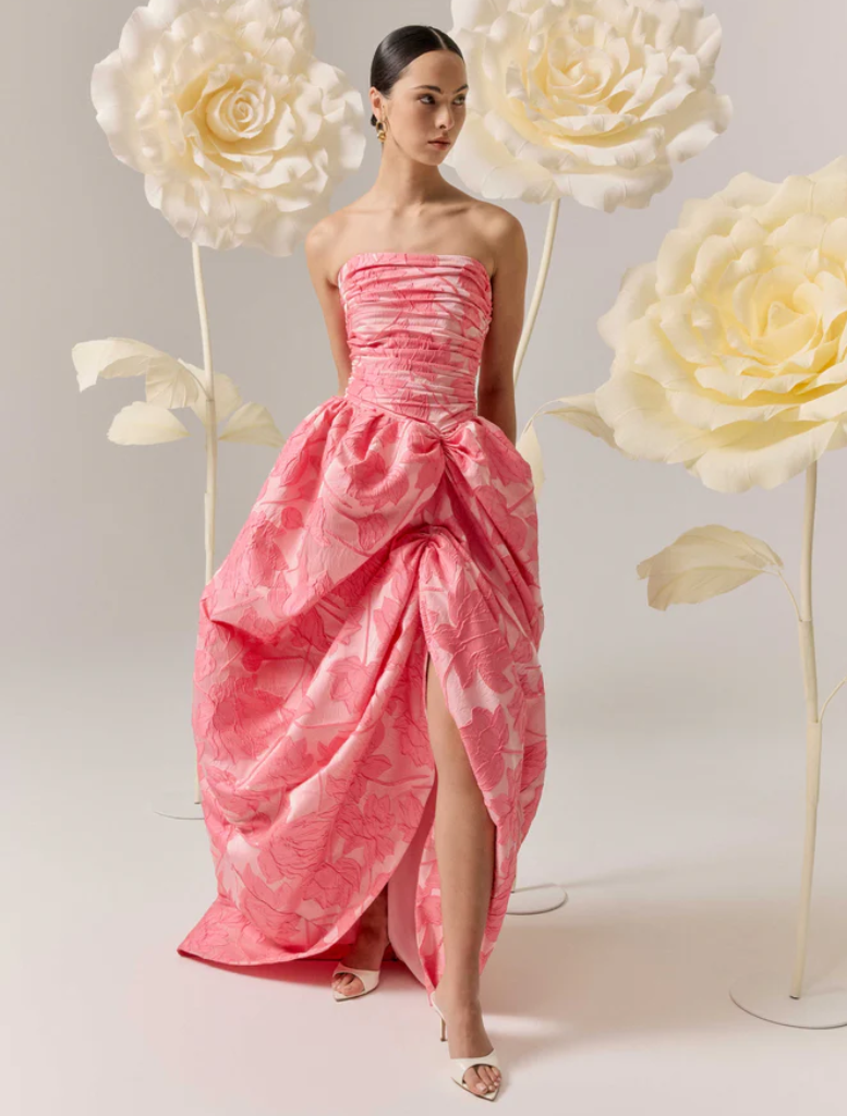 Elegant pink strapless ball gown featuring a structured bodice and a voluminous skirt, ideal for special events.