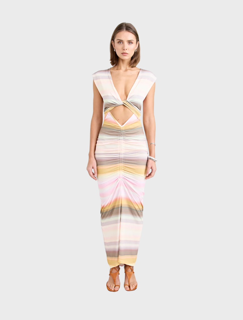 Elegant Elara Dress in a soft peach hue, designed with a flattering fit for various occasions.