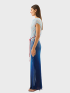 Flowing Capri maxi dress showcasing a bold striped design, inspired by the colors of the ocean.