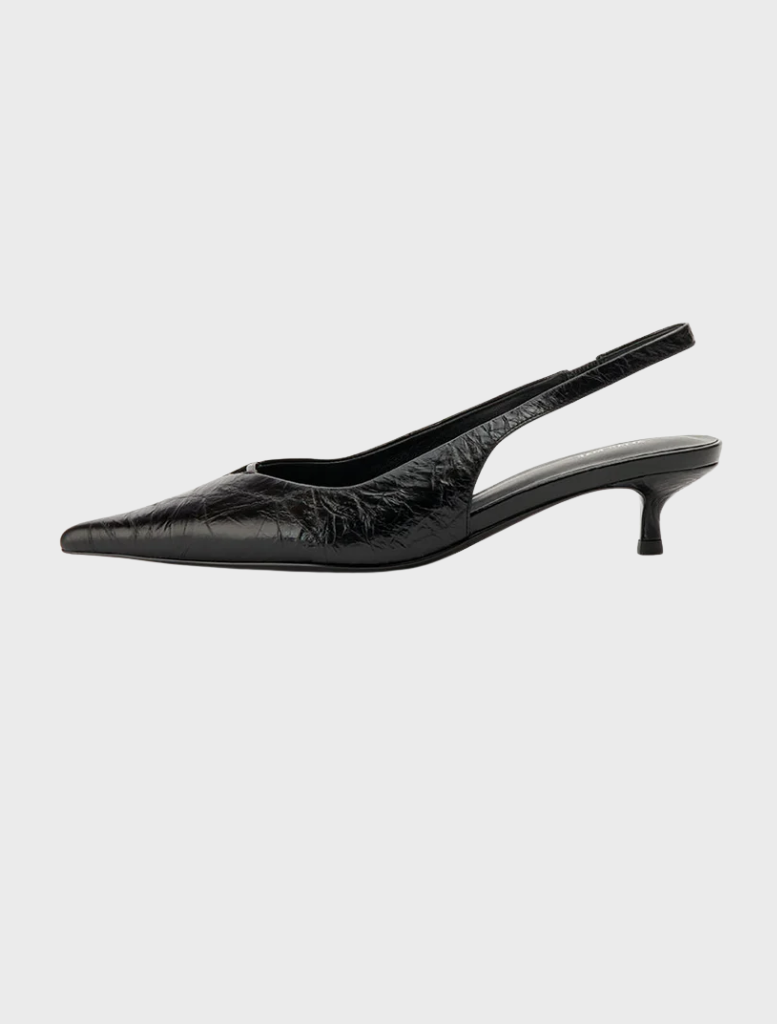 Black leather sling heel shoe with a pointed toe, made from Evette's black oily crinkle leather.