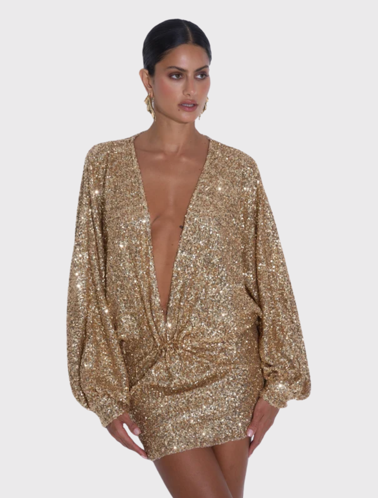 Gold glitter mini dress with a plunging neckline and long sleeves, featuring a relaxed drape and raw hemline finish.