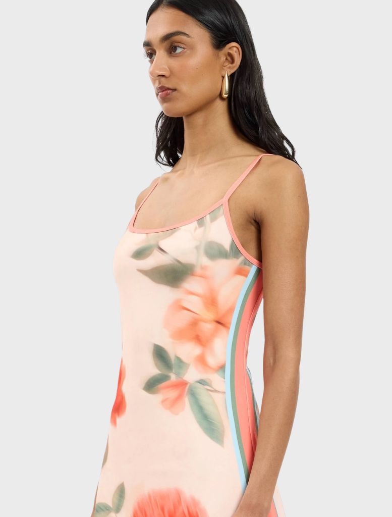 Stylish fitted mini dress in peach adorned with a delicate floral design, perfect for casual or semi-formal occasions.