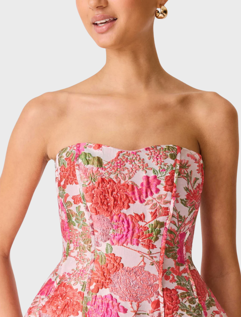 Pink floral strapless mini dress with a fitted bodice and flared skirt, perfect for summer occasions.