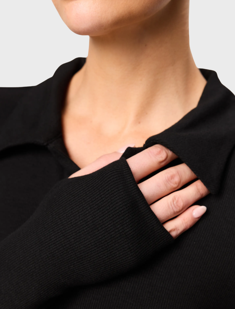 Elegant black polo top from Florence, designed for versatility and comfort, perfect for everyday wear.