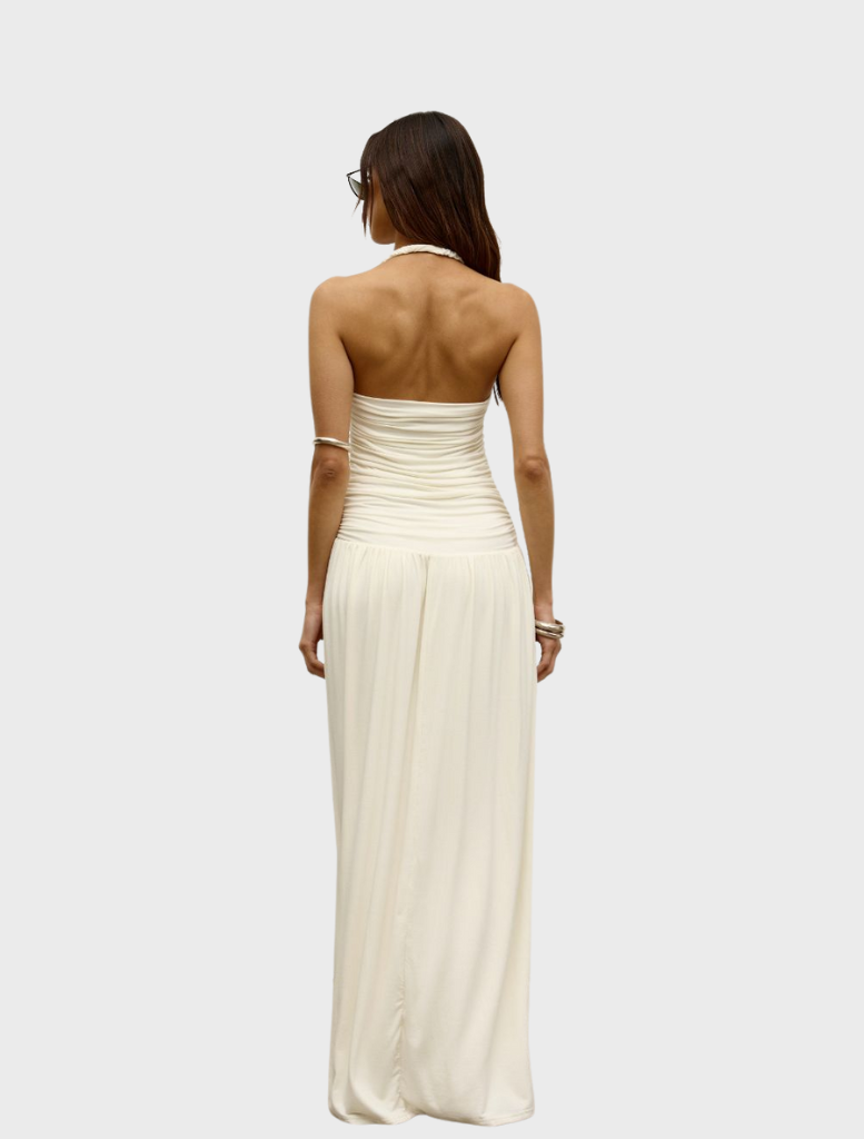 Back view of a woman in an ivory Frances dress, showcasing its elegant design and flowing silhouette.
