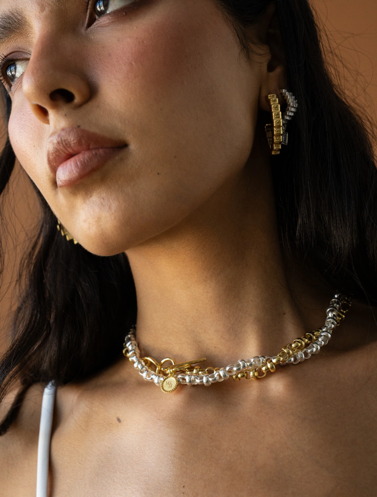 Sophisticated gold Gabrielle earrings, designed to add a touch of elegance to any ensemble.
