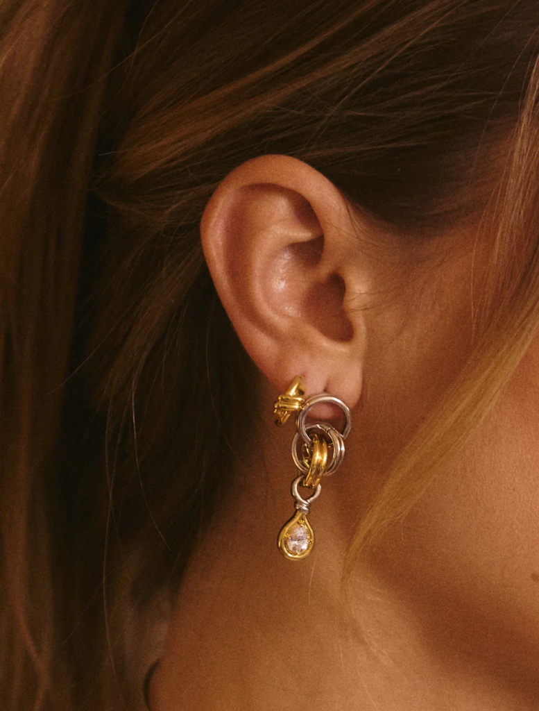 Elegant two-tone gold and white diamond drop earrings, The Georgia Stone Twisted Studs - Gold, showcasing a unique twisted style.