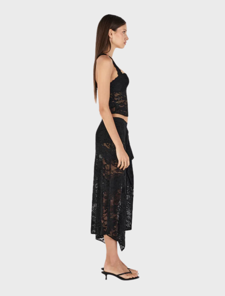 Black Gigi wrap skirt featured on a display, illustrating its chic design and adjustable waist tie for a perfect fit.