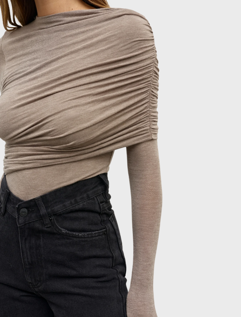A grey marle bodysuit named Ariya, hanging to highlight its modern cut and comfortable material.