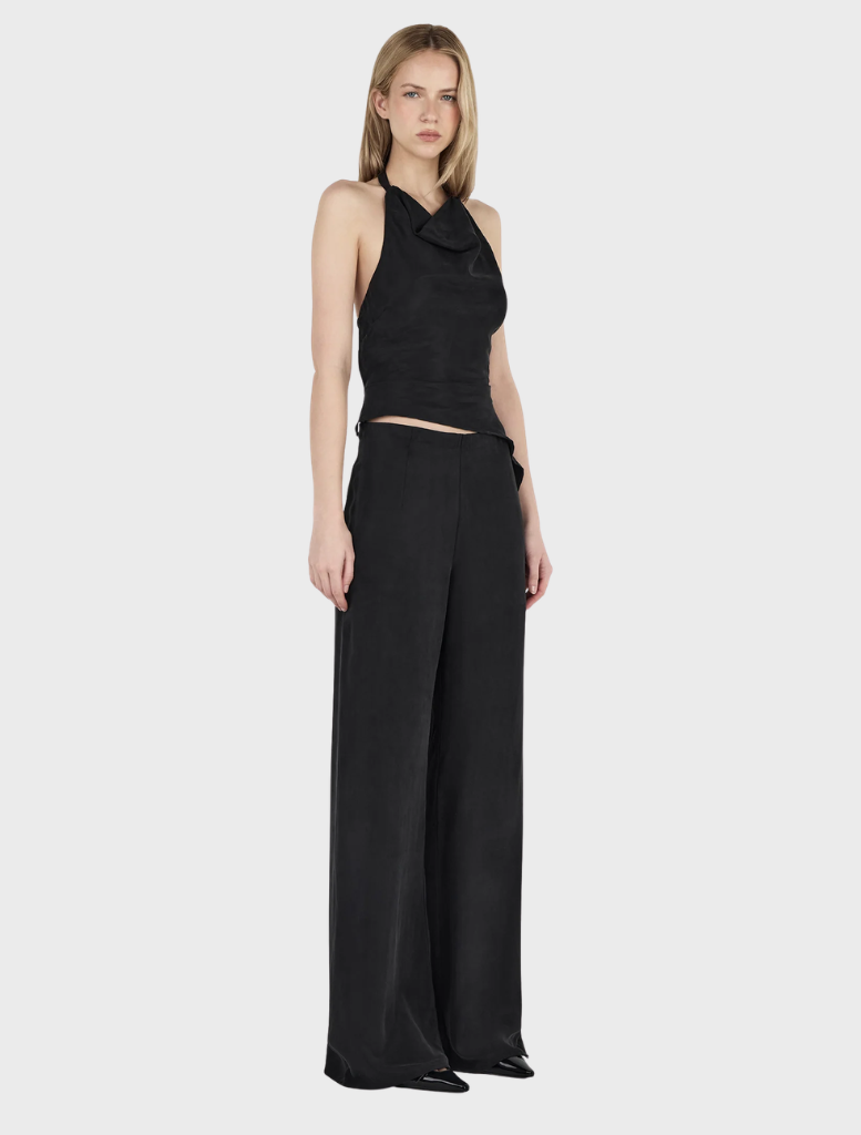Stylish cropped top in black leather, named Iris Halter Top, emphasizing contemporary fashion.