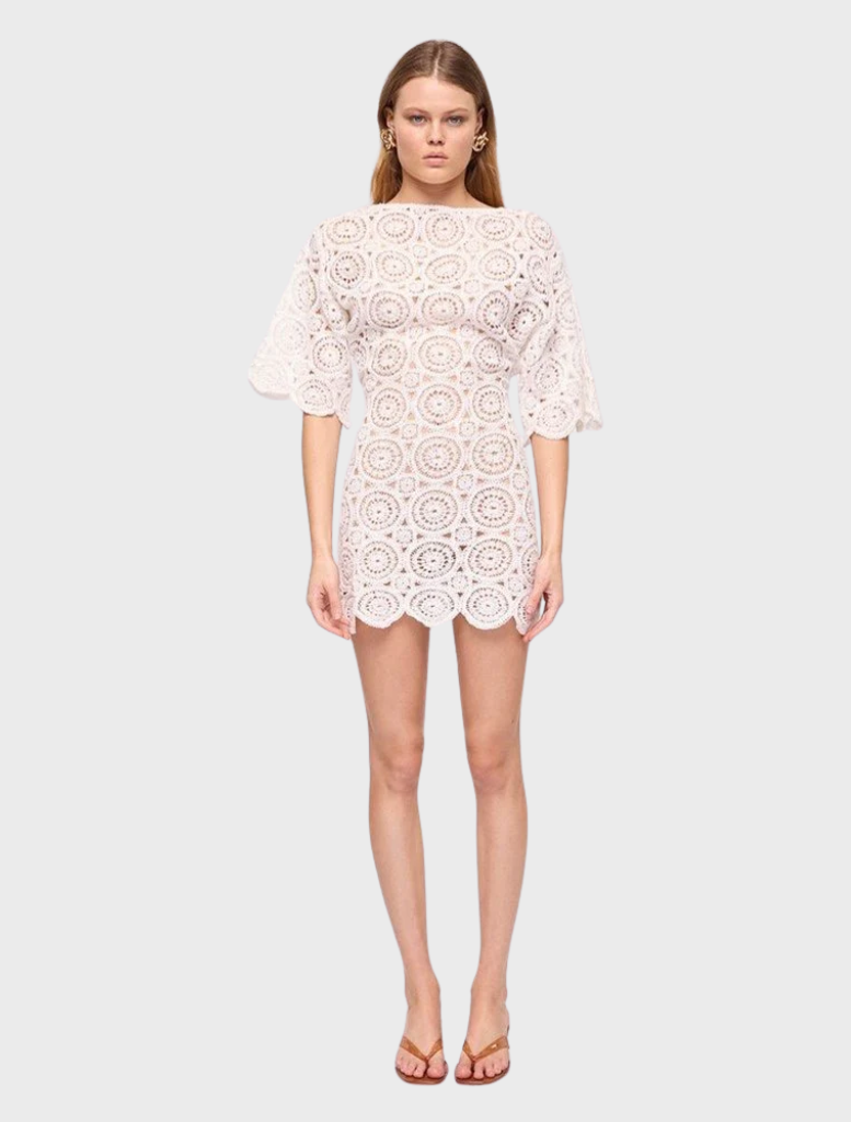 Ivory crochet mini dress with a delicate design, featuring short sleeves and a fitted silhouette, perfect for summer outings.