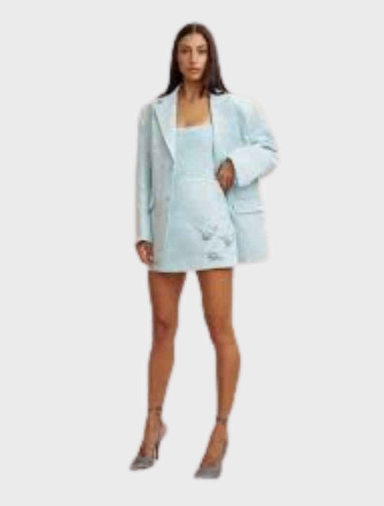 Ice blue mini skirt with an A-line silhouette, adorned with handmade rosettes, made from structured twill and fully lined.