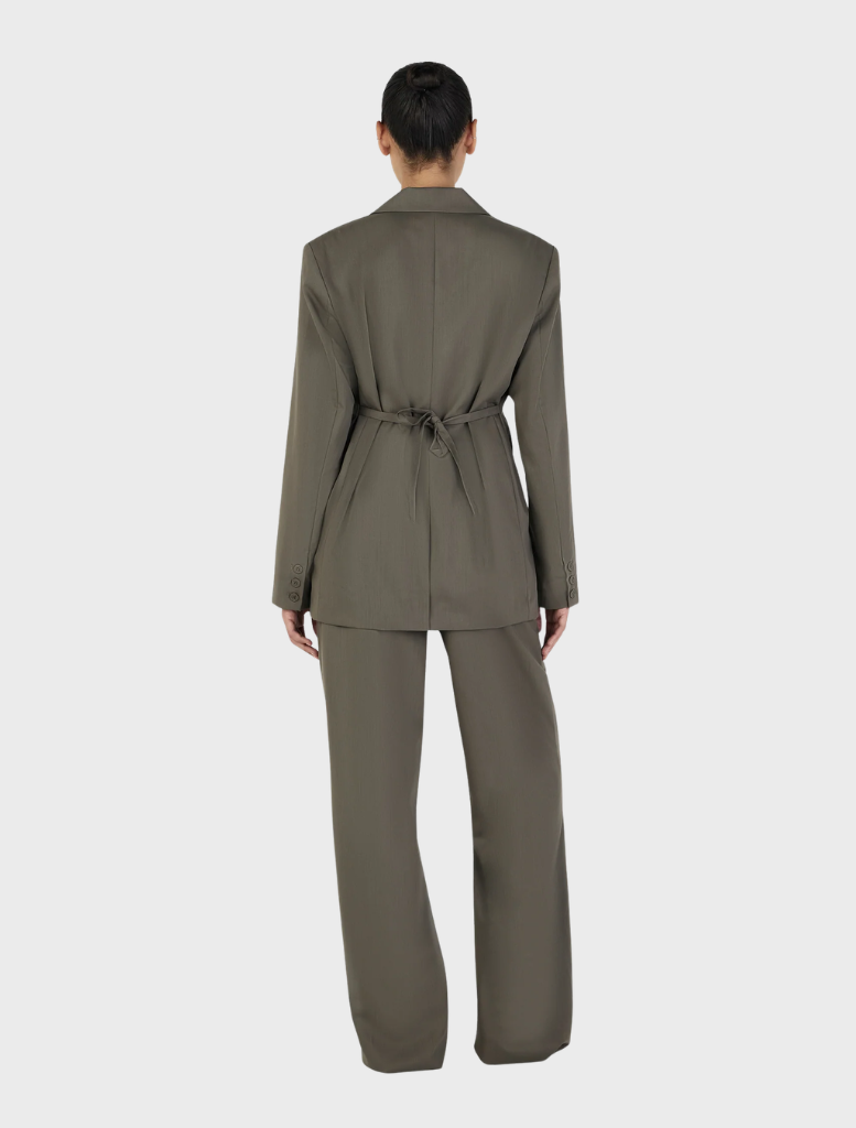 Elegant forest green Isla Blazer on a hanger, highlighting its sophisticated style and tailored details.