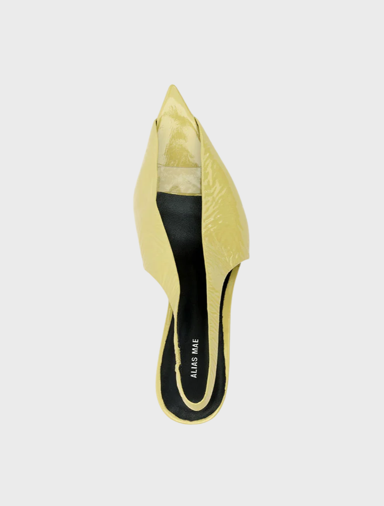 Yellow leather mules with a pointed toe, featuring a crinkled texture and a pistachio oily finish.