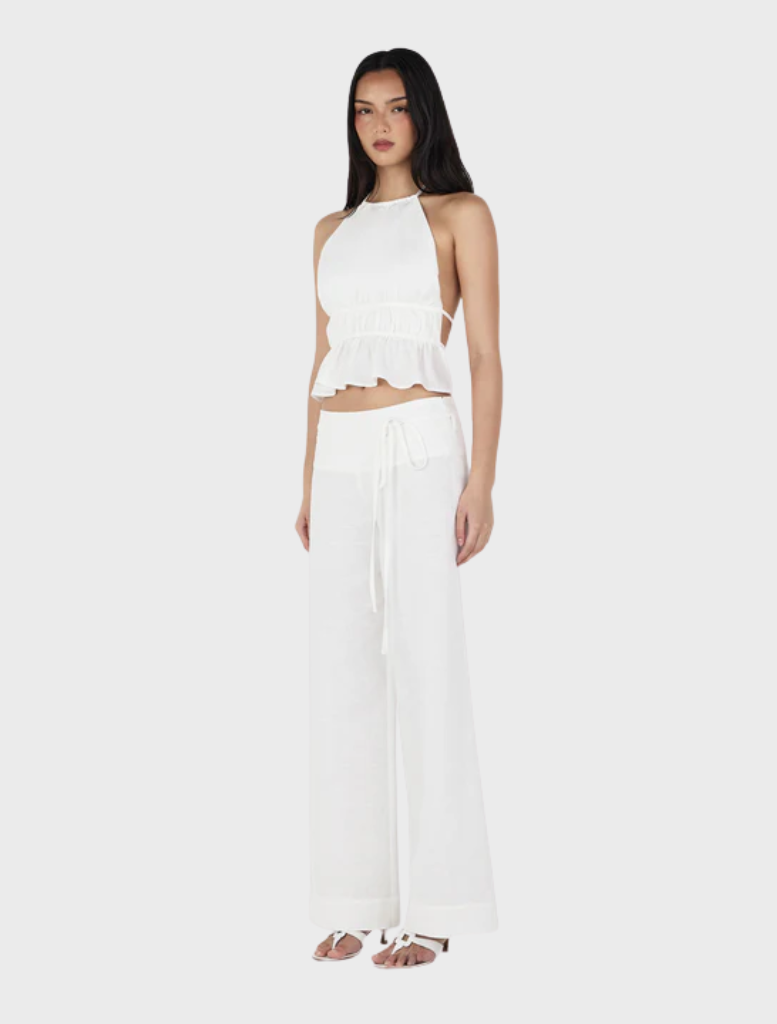 A pair of ivory Casey pants shown against a neutral backdrop, emphasizing their chic design and versatility for different looks.