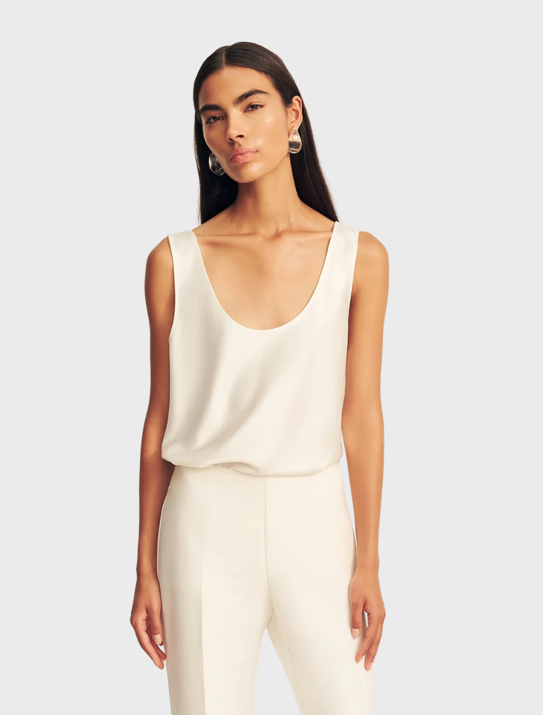 A pair of ivory Otis Pants laid flat, highlighting the fabric and tailored fit.