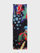 A neutral grey Swim Jungle Dress draped elegantly, emphasizing its casual style and eye-catching tropical details.