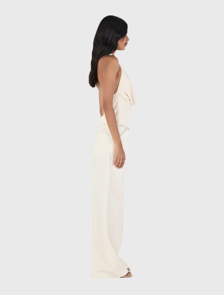 Cream cargo pant with a relaxed fit, low-rise design, zip fly, belt loops, and practical front and back pockets.
