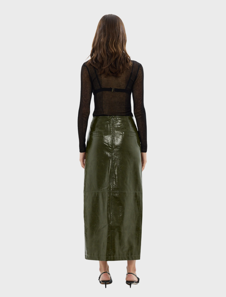 A model wearing a khaki Raye maxi skirt, demonstrating its stylish fit and versatility for different outfits.