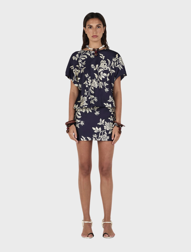 Model wearing the Kodie Mini Dress in navy and white floral print, titled Moonlit Vine.