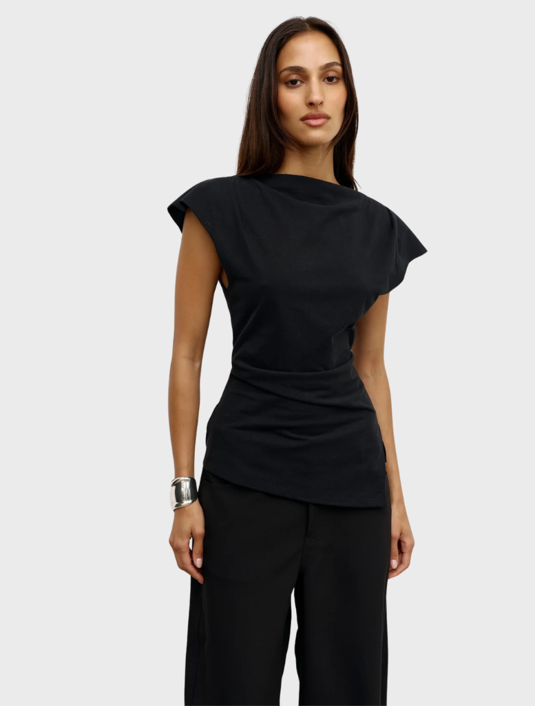 Black Liana top presented on a hanger, emphasizing its contemporary cut and fabric quality.