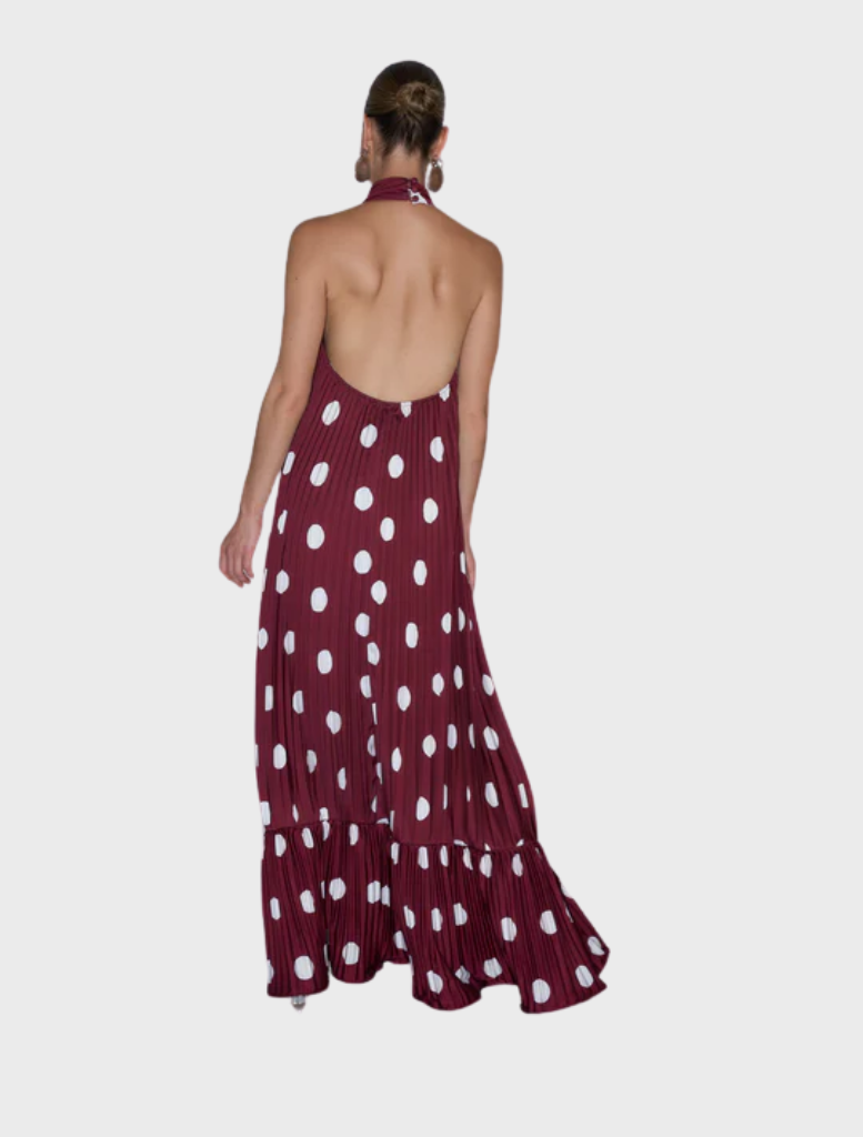 The image features a model in a maroon polka dot dress, emphasizing a chic and trendy look.
