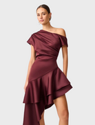 Elegant burgundy satin Livia Gown with a unique asymmetric hem, ideal for special events.