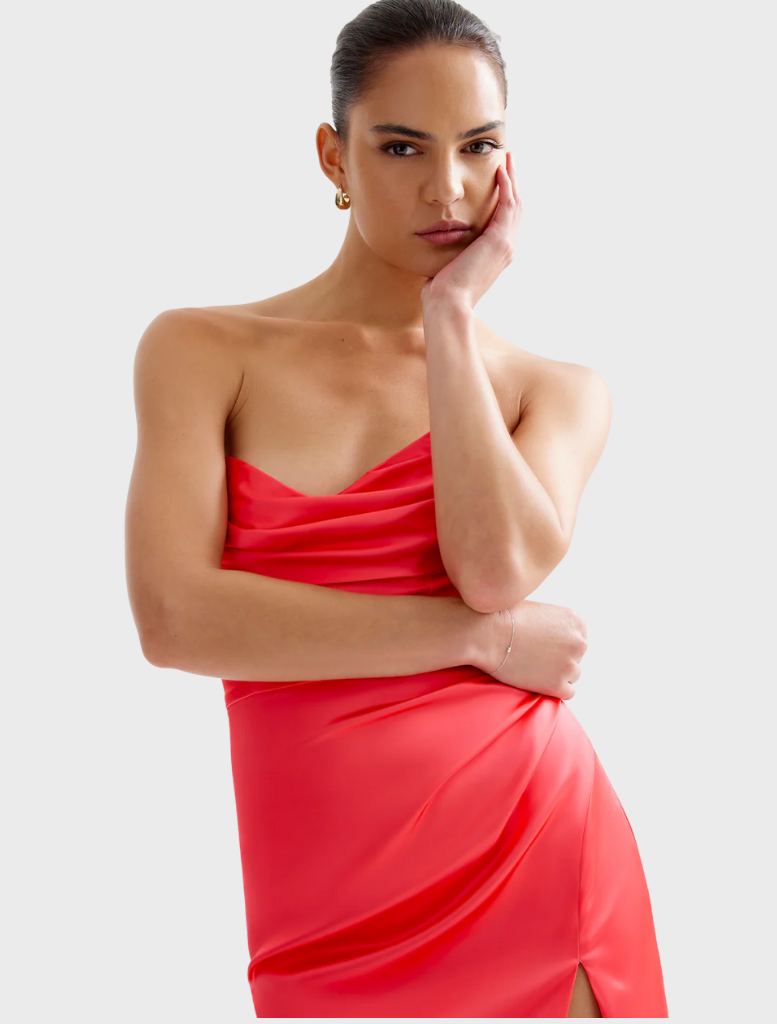 Chic Lucy dress in cranberry, showcasing a fitted top and a voluminous skirt, perfect for any special event.