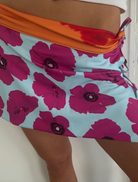 A woman showcase skirt, presenting a bright and trendy summer fashion choice.