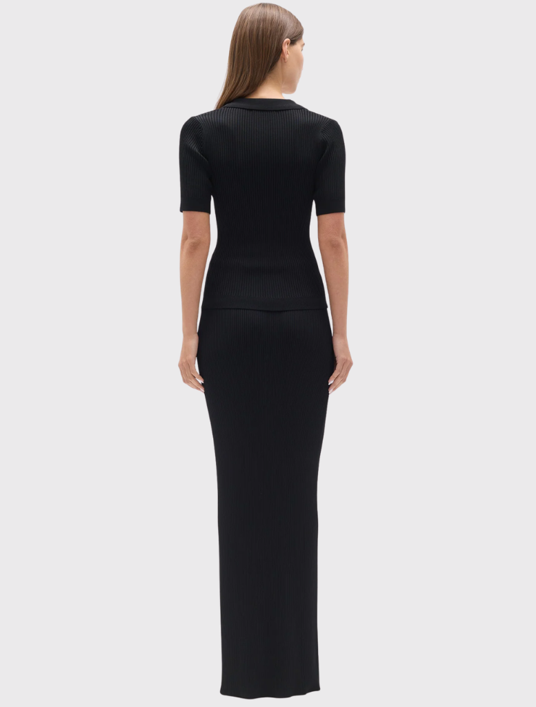 Fitted black knit polo with a ribbed texture, V neckline, short sleeves, and flap-detail chest pockets.