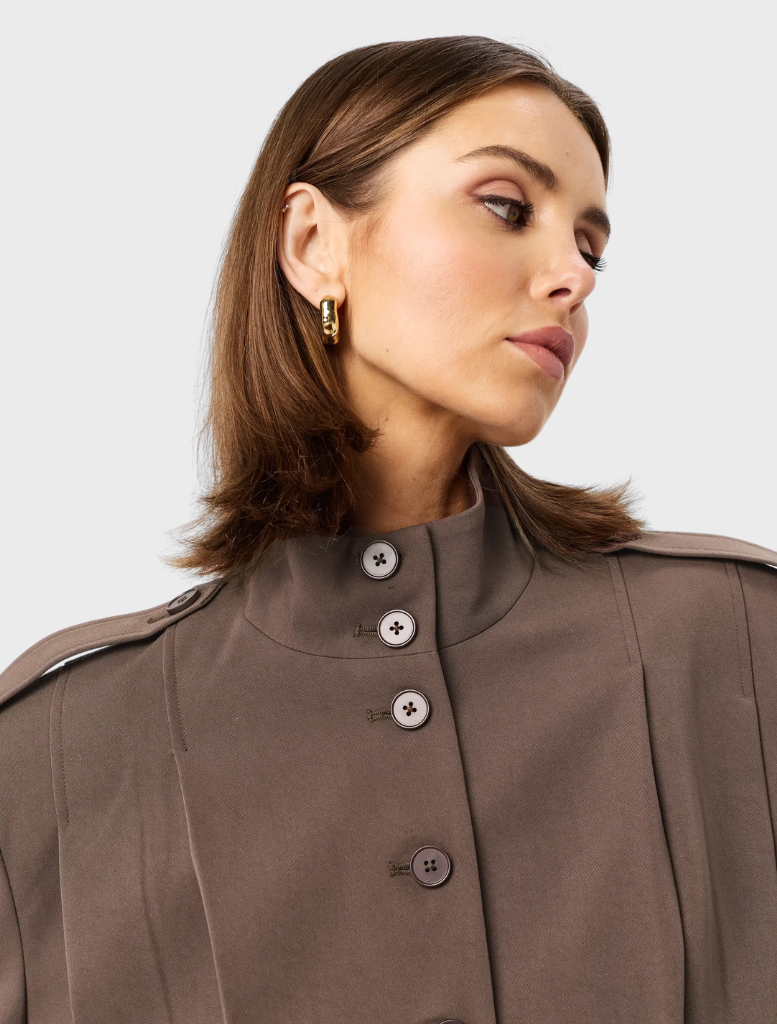 Mocha Vault Bomber jacket featured on a hanger, highlighting its modern style and rich color.