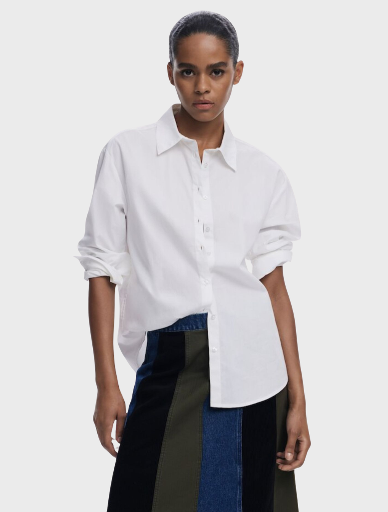 A multi-patterned Evase skirt draped on a hanger, emphasizing its vibrant colors and graceful design.