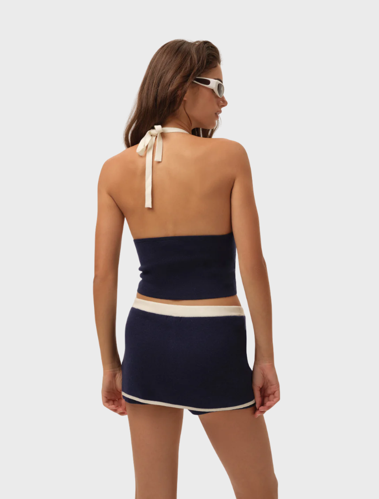 Navy Caroline Top displayed on a hanger, featuring a sleek design and soft fabric suitable for casual or formal wear.