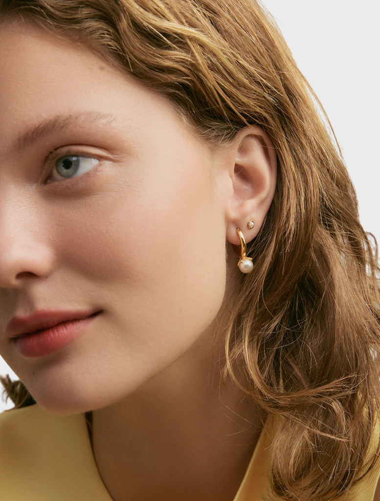 Elegant gold Nisha Hoops, featuring a contemporary design that enhances any outfit with a touch of sophistication.