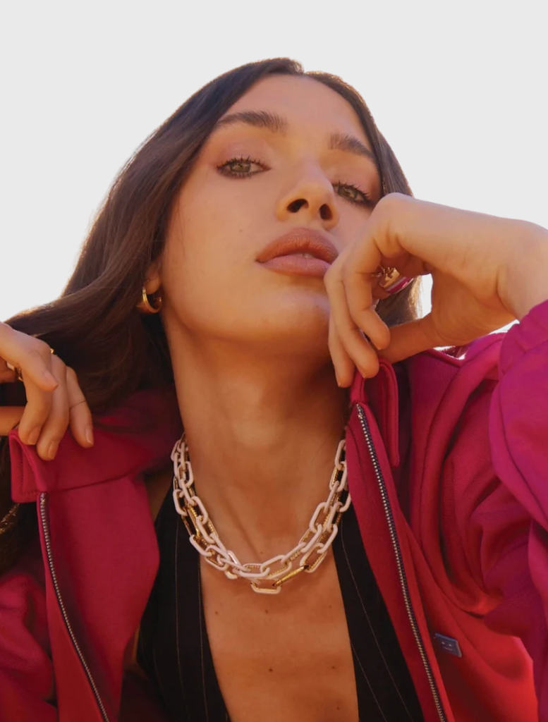 The OG Necklace in White Glo is a best-selling 14k gold-plated enamel chain, adjustable to 18 inches, inspired by OG earrings.