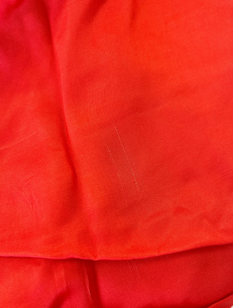 Elegant orange maxi dress featuring long sleeves and a relaxed fit, ideal for warm weather events.