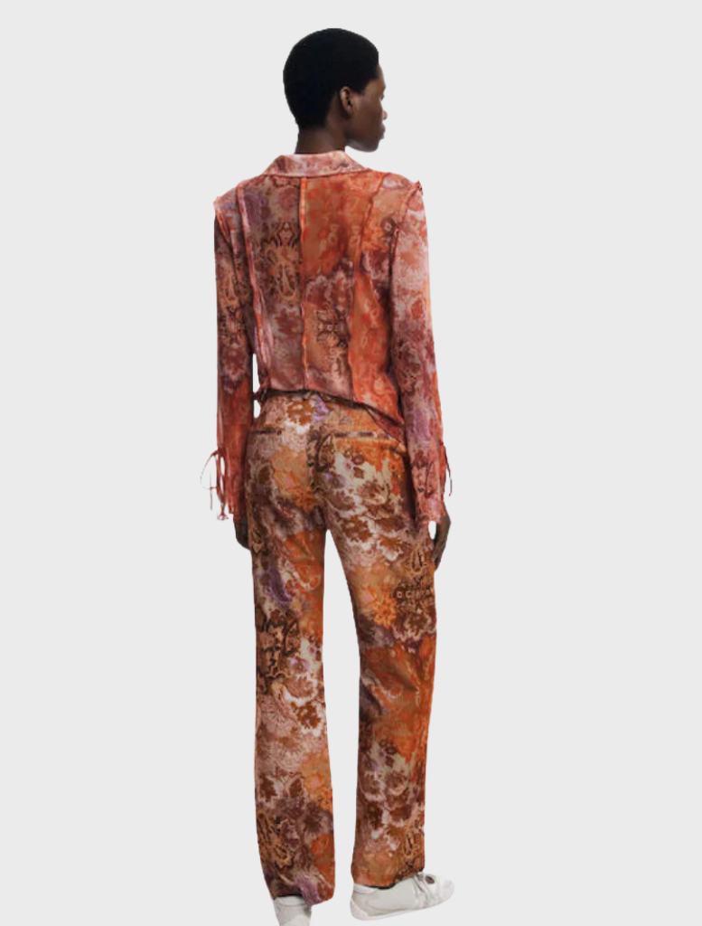 A pair of long orange trousers laid flat, highlighting their bright color and casual design suitable for various occasions.