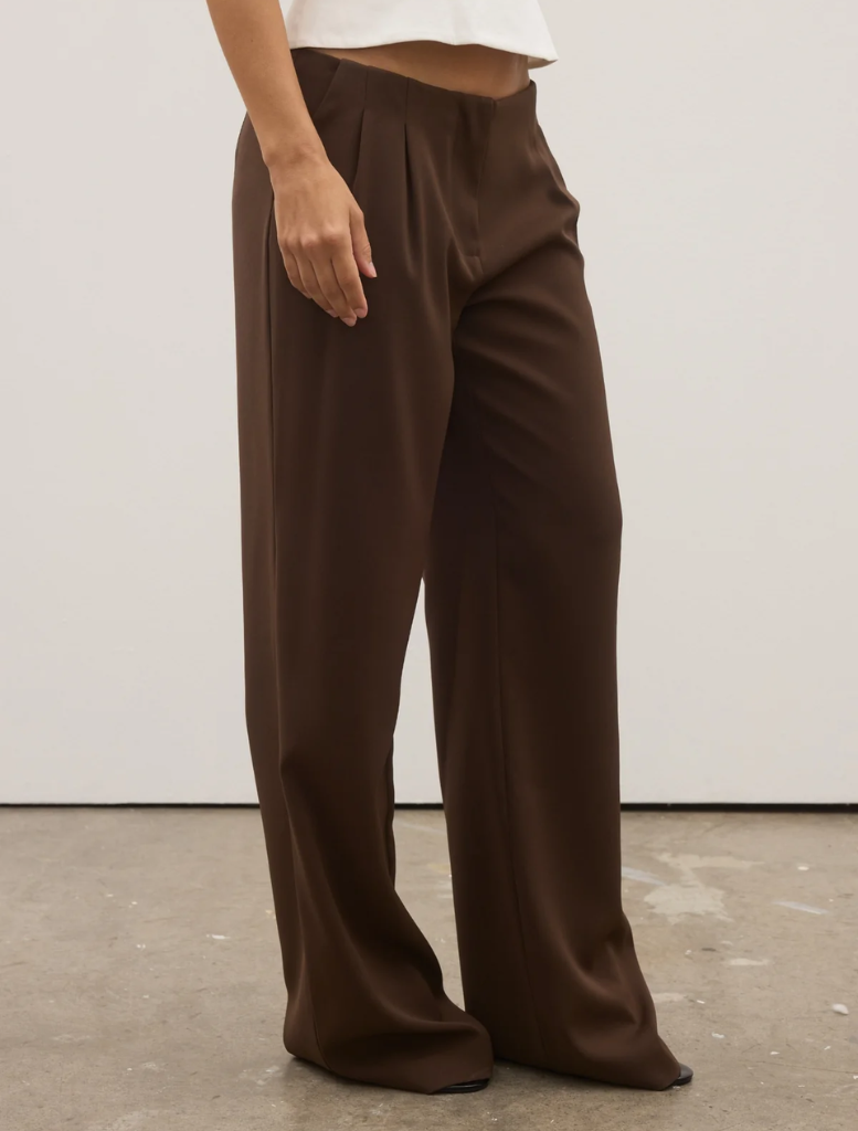 Full view of chocolate Pietra Pant, emphasizing its modern cut and stylish appearance.