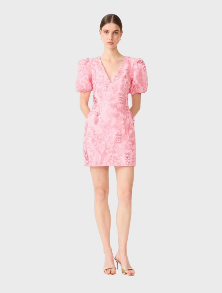 Elegant pink mini dress with puff sleeves and a flared silhouette, designed by Monique for a stylish, feminine look.