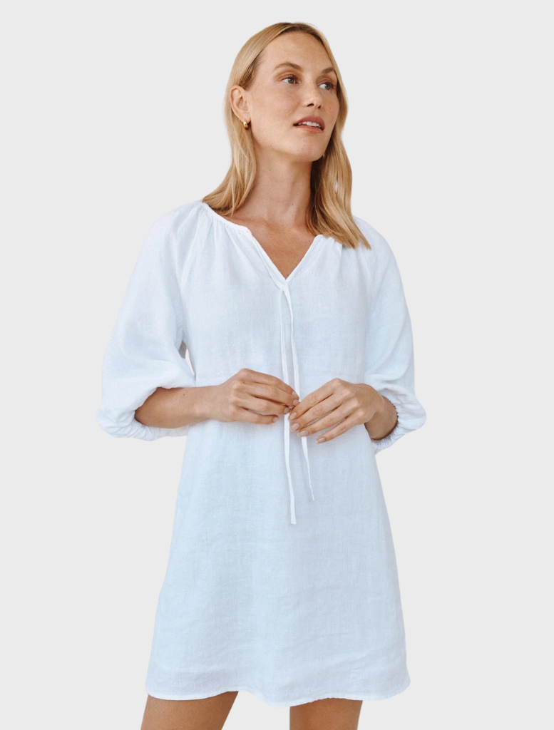White dress with puff sleeves and a pullover design, offering a chic and comfortable look.