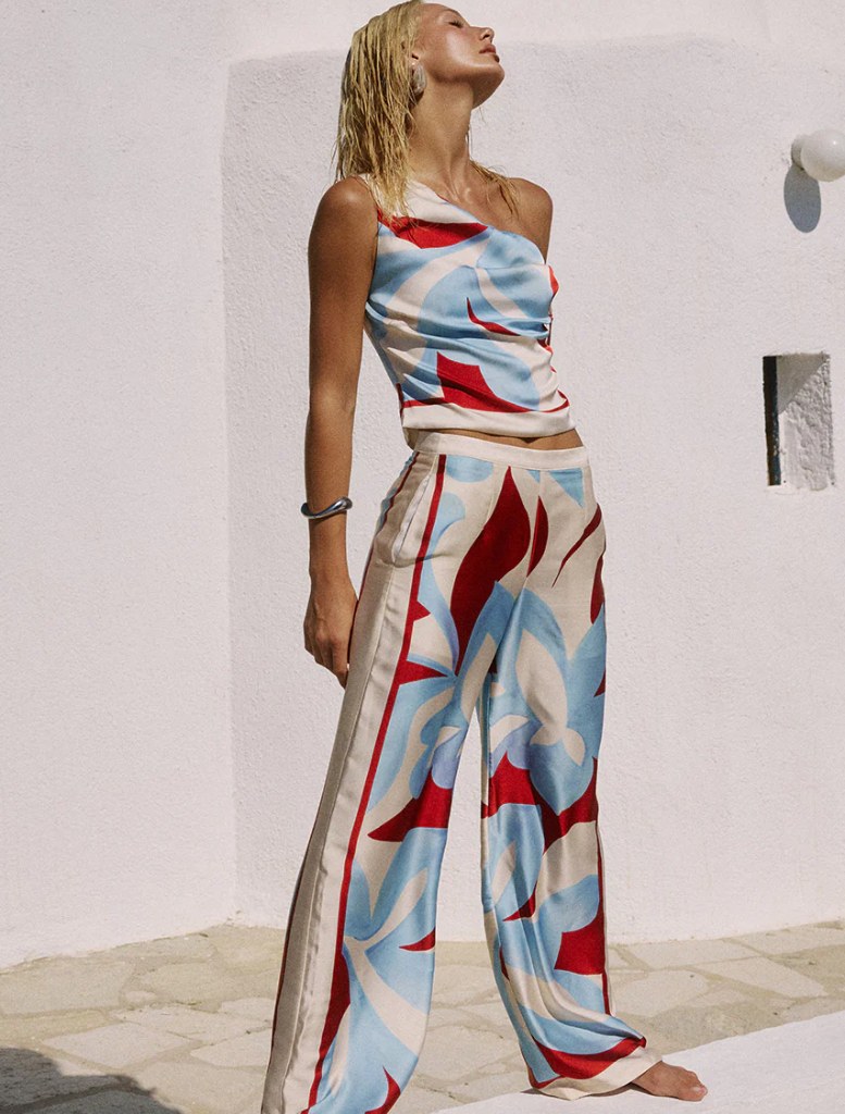 Amoree One Shoulder Tie Top, presented in bright Amoree Red, with a trendy one-shoulder cut and stylish tie feature.