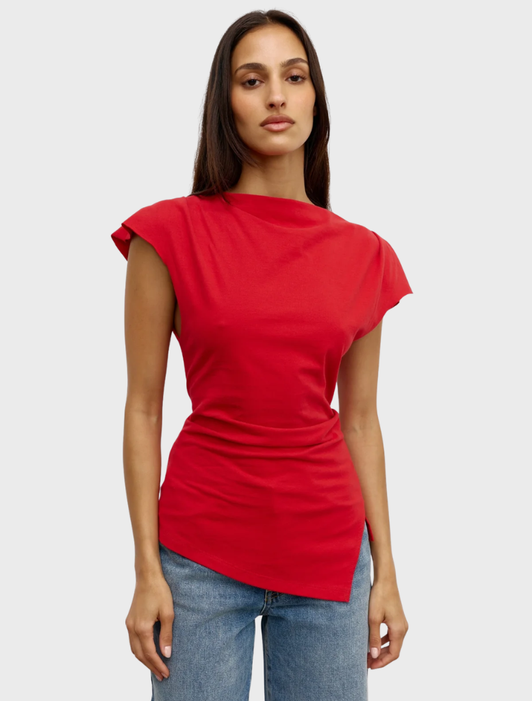A red Liana top hanging, highlighting its elegant cut and fabric texture.