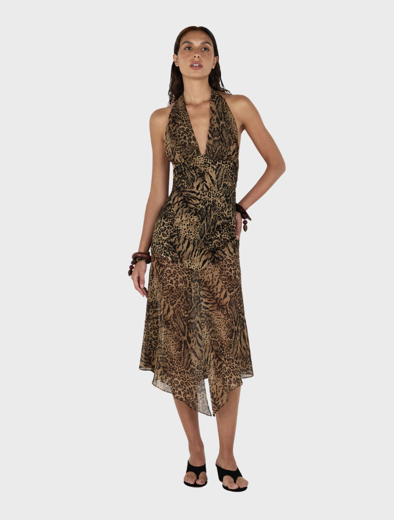 Model showcases the Saffron Midi Dress in a stylish leopard print design.