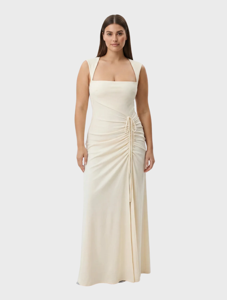 A stunning butter-colored Samara gown, characterized by its elegant lines and sophisticated draping.