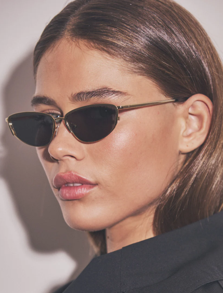 A detailed image of Santal leaves, displaying their glossy surface and intricate veins, set against a soft-focus backdrop.