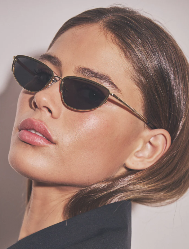 An expansive field of Santal trees, their distinct shapes silhouetted against a sunset, creating a peaceful atmosphere.