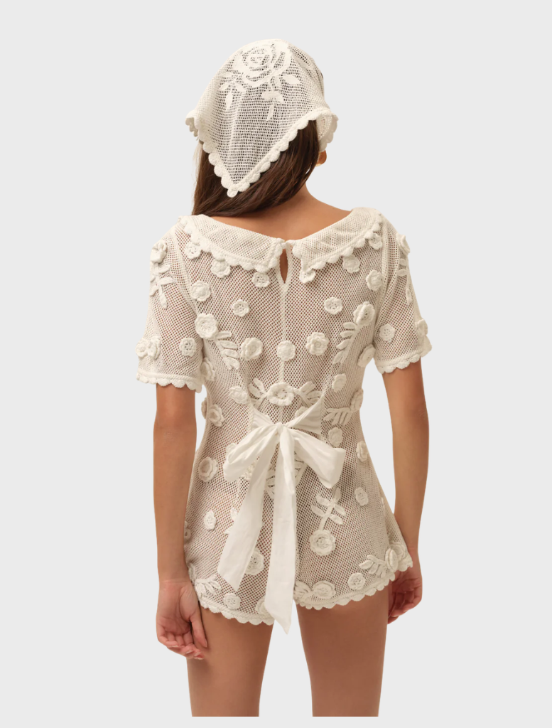 Elegant white Sara romper, ideal for warm weather, showcasing a chic and comfortable fit.