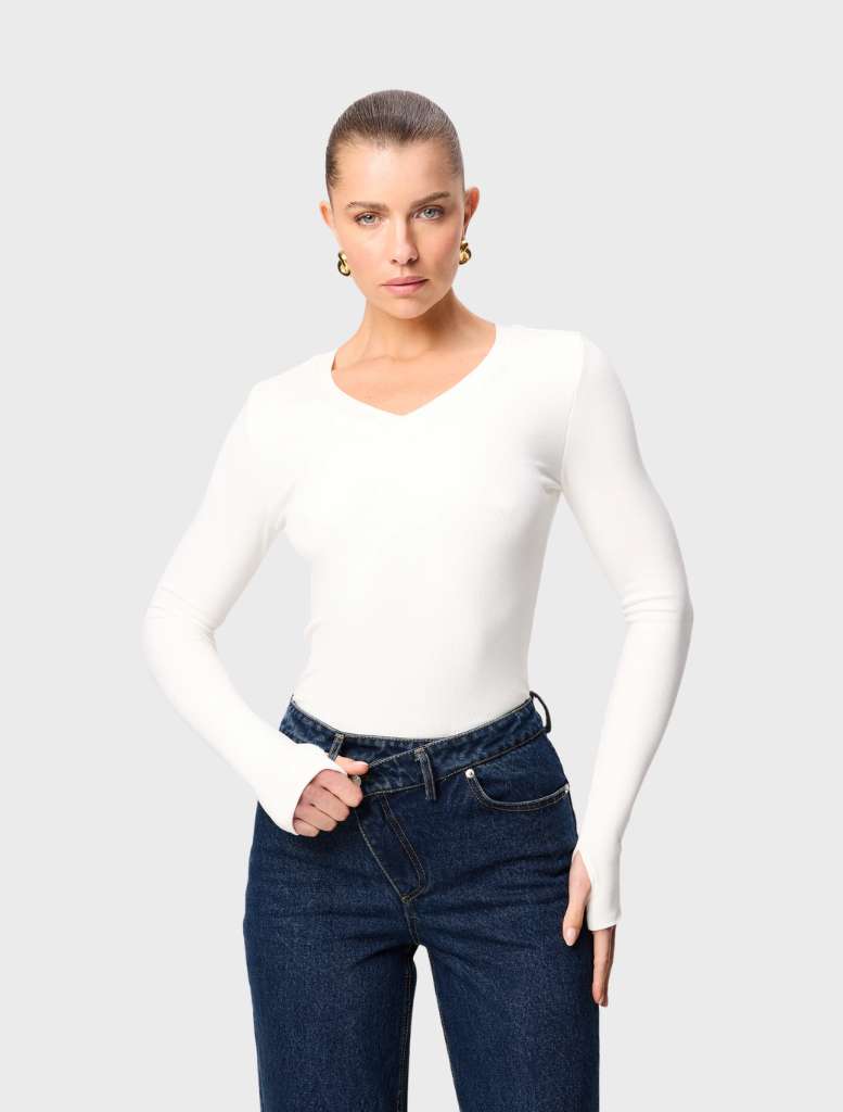 White Sedona top displayed on a hanger, featuring a simple design and lightweight fabric suitable for casual wear.