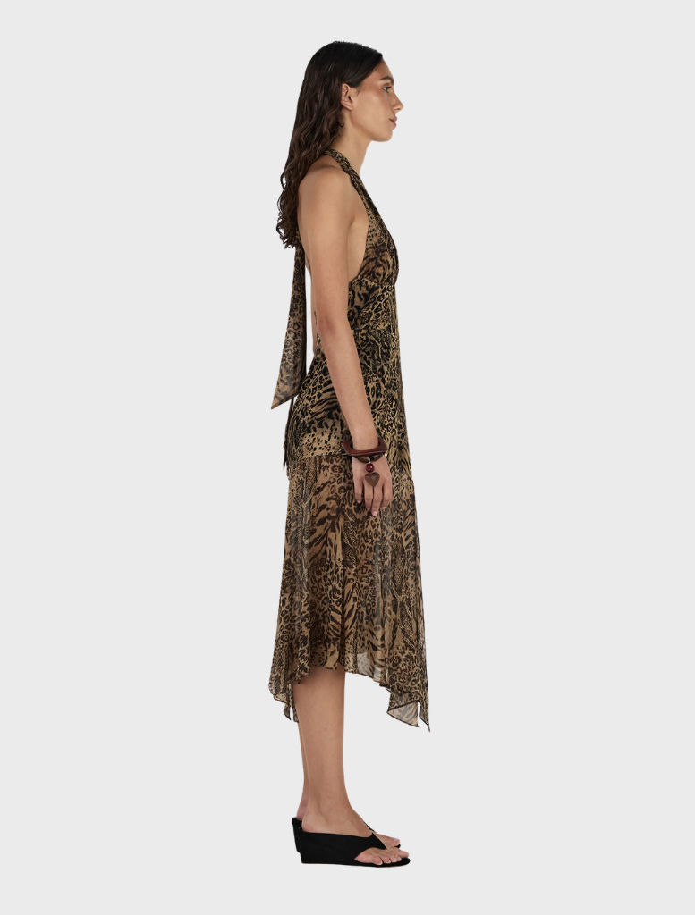 The Saffron Midi Dress features a chic leopard print worn by the model.