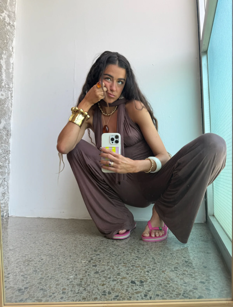 A gold bracelet adorned with a large spherical charm.